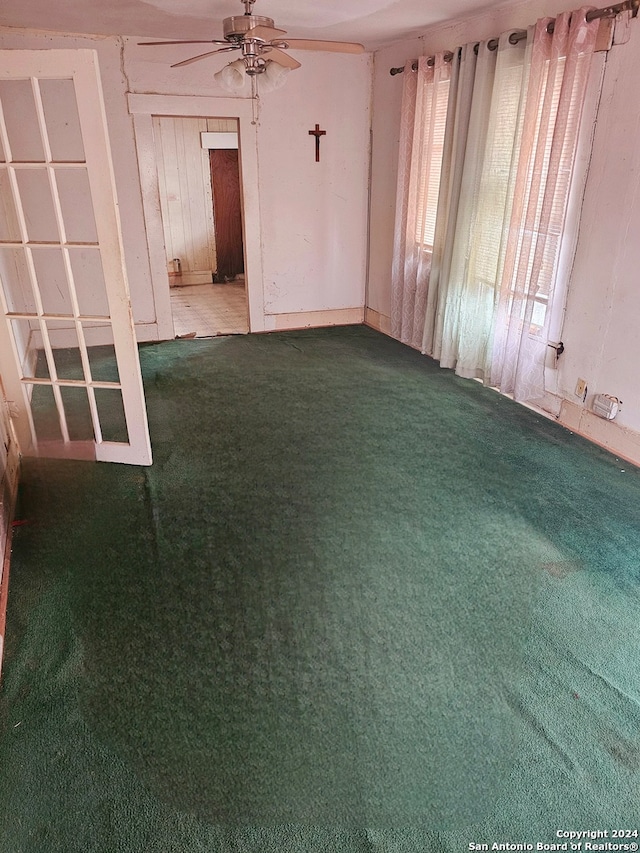 carpeted empty room with ceiling fan