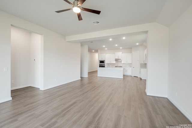 unfurnished living room with ceiling fan and light hardwood / wood-style floors