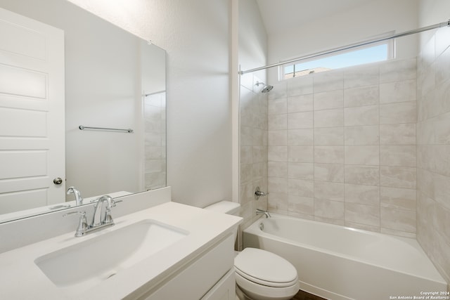 full bathroom with toilet, tiled shower / bath, and vanity