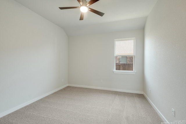 carpeted empty room with ceiling fan and lofted ceiling