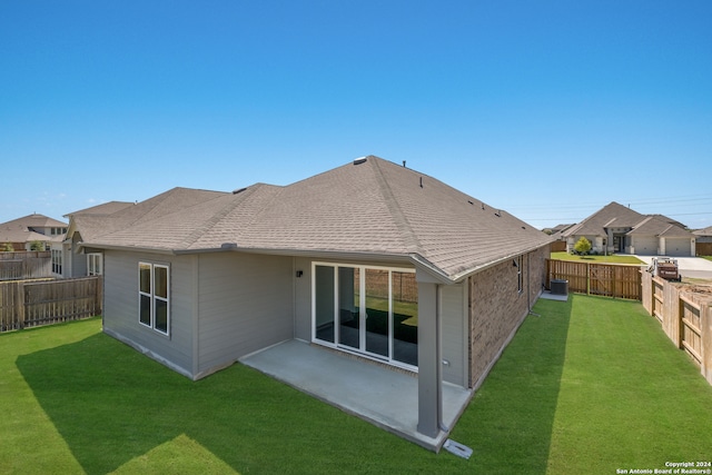 back of house featuring a patio area and a yard