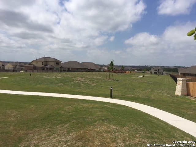 view of property's community featuring a lawn