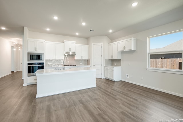 kitchen featuring stainless steel appliances, light hardwood / wood-style floors, and white cabinets