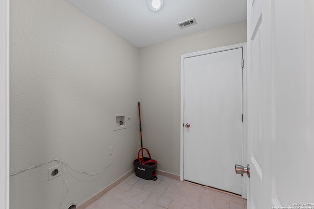 laundry area with washer hookup, a textured ceiling, and electric dryer hookup