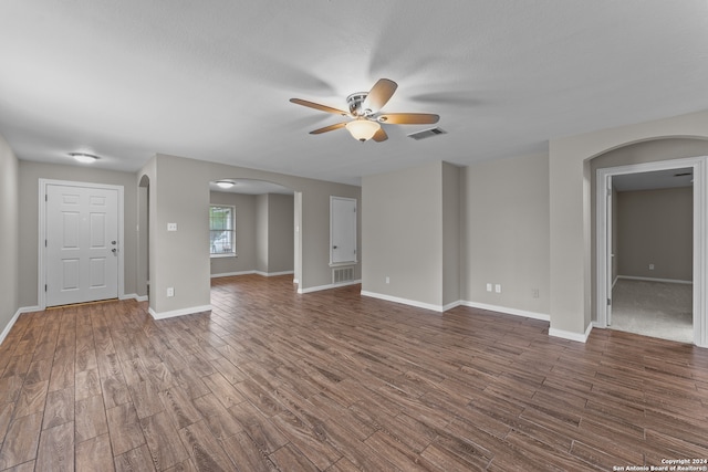 spare room with ceiling fan and dark hardwood / wood-style flooring