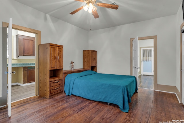 bedroom featuring ensuite bath, dark hardwood / wood-style floors, and ceiling fan