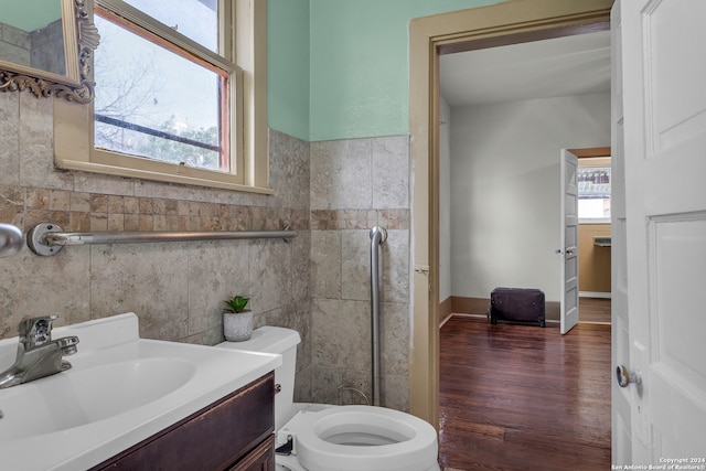 bathroom featuring toilet, a wealth of natural light, hardwood / wood-style floors, and vanity