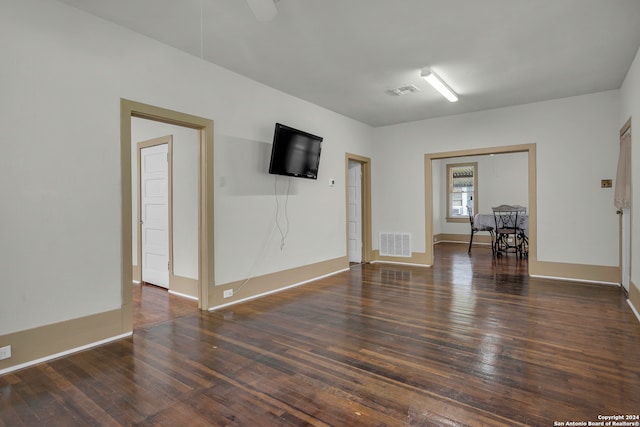 spare room with dark hardwood / wood-style floors and ceiling fan