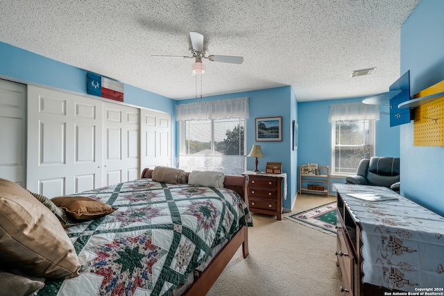 bedroom featuring light carpet, multiple windows, and ceiling fan