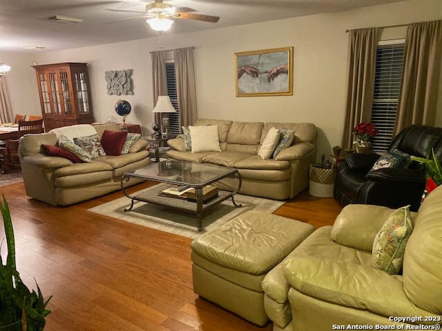 living room featuring hardwood / wood-style flooring and ceiling fan