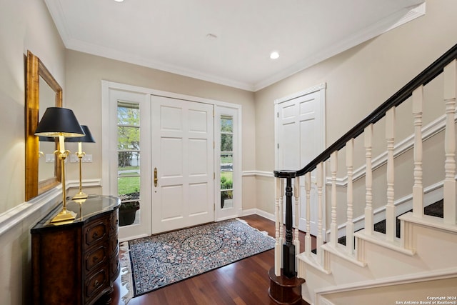 entrance foyer with dark hardwood / wood-style flooring and crown molding