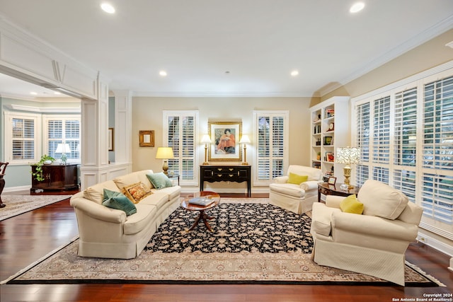 living room with ornamental molding, decorative columns, and dark hardwood / wood-style floors