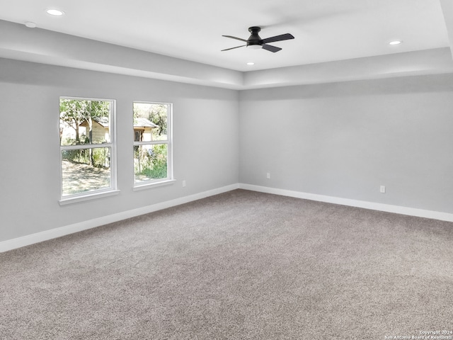 empty room featuring ceiling fan and carpet floors