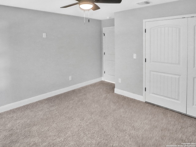 spare room featuring ceiling fan and light carpet