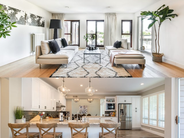 interior space with stainless steel fridge, a breakfast bar area, pendant lighting, and plenty of natural light