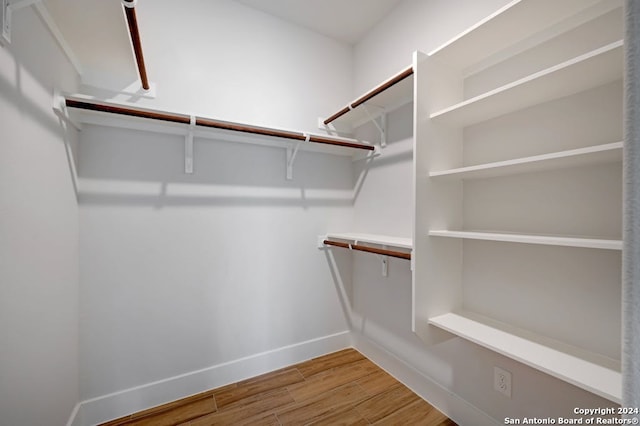 spacious closet with light hardwood / wood-style floors