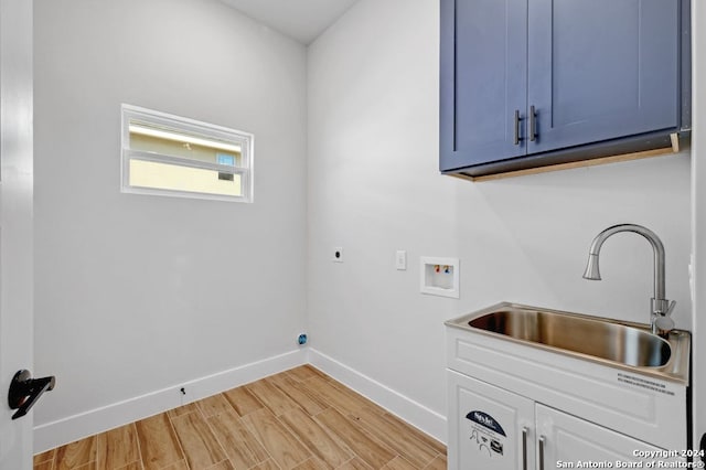 washroom with cabinets, sink, light wood-type flooring, electric dryer hookup, and hookup for a washing machine