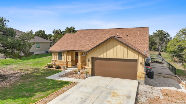 view of front of property featuring central AC, a front yard, and a garage