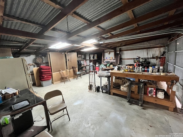 interior space featuring a workshop area and white fridge