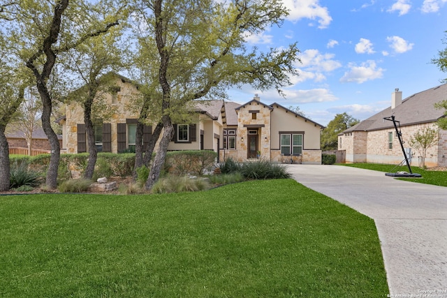 mediterranean / spanish home featuring a front lawn