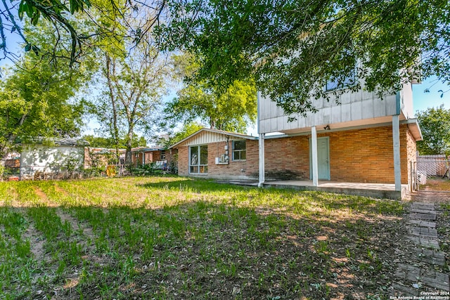 rear view of house with a yard