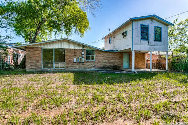 back of house featuring a patio and a yard