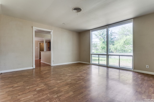 spare room with dark hardwood / wood-style flooring