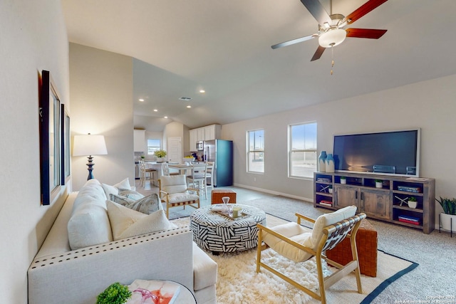 living room featuring ceiling fan, lofted ceiling, and light carpet