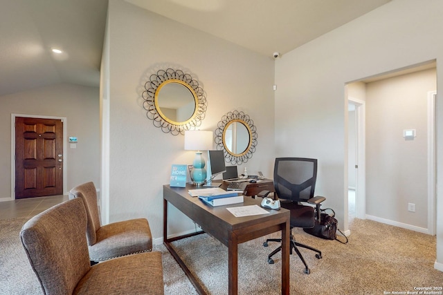 office space with vaulted ceiling and light colored carpet