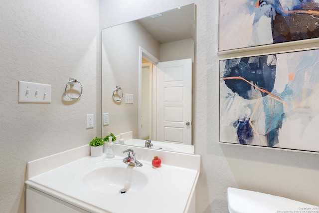 bathroom featuring toilet and vanity