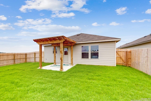 rear view of property with a yard and a patio