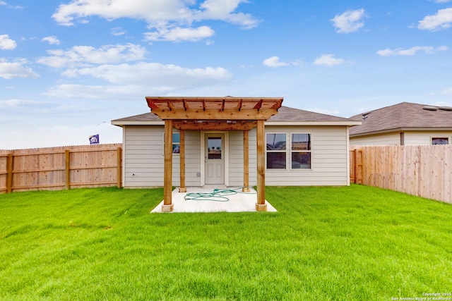 back of property featuring a pergola and a yard