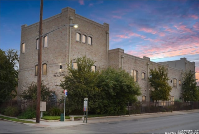 view of outdoor building at dusk