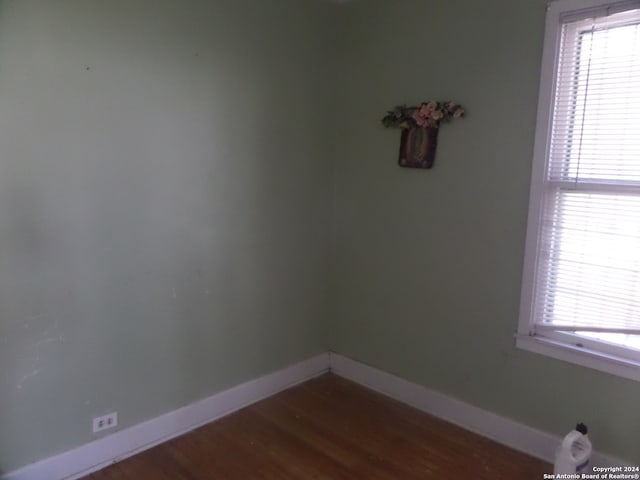 spare room featuring dark wood-type flooring