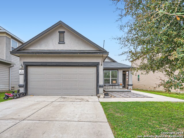 view of front of home with a front lawn and a garage