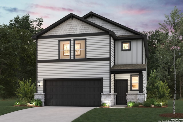 craftsman inspired home featuring a garage and a lawn