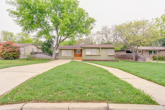 single story home with a front lawn