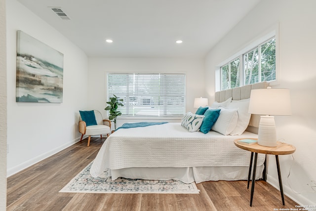 bedroom with dark hardwood / wood-style floors