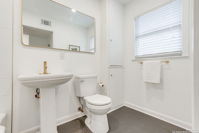 bathroom featuring tile floors and toilet