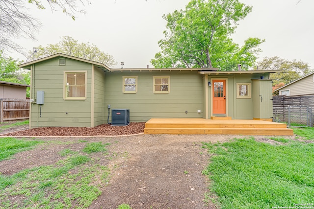 back of property featuring a deck and central air condition unit