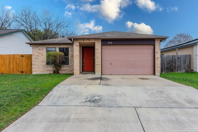 ranch-style house featuring a front yard and a garage