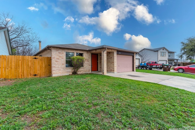 view of front of house featuring a front lawn and a garage