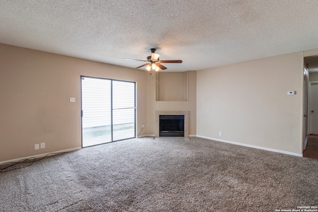 unfurnished living room featuring ceiling fan, a textured ceiling, and carpet flooring