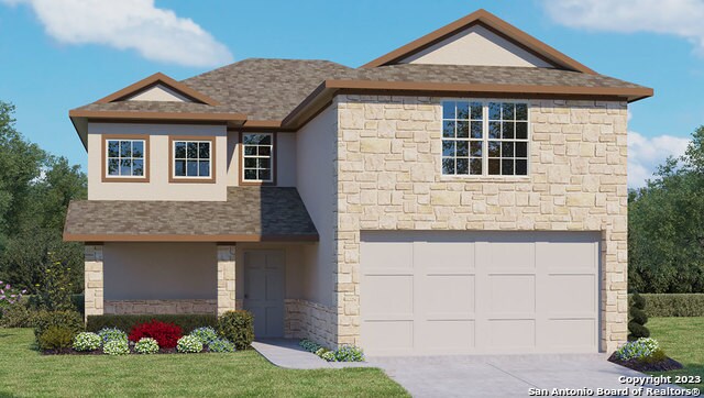 front facade featuring a front yard and a garage