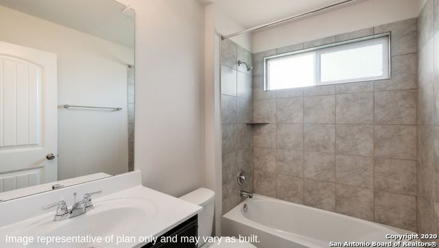 full bathroom featuring toilet, vanity, and tiled shower / bath