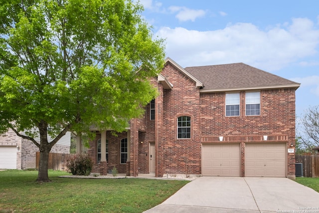 view of front of home with a front lawn and a garage