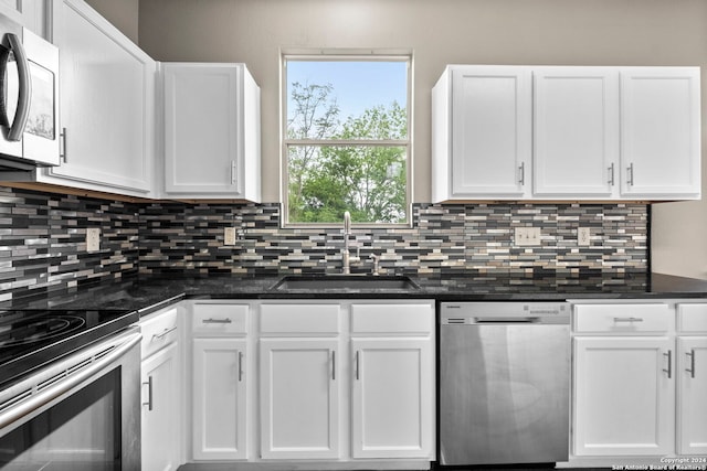 kitchen with white cabinetry, tasteful backsplash, sink, and stainless steel appliances