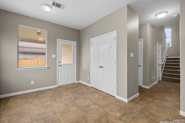 entryway with a healthy amount of sunlight and light tile flooring