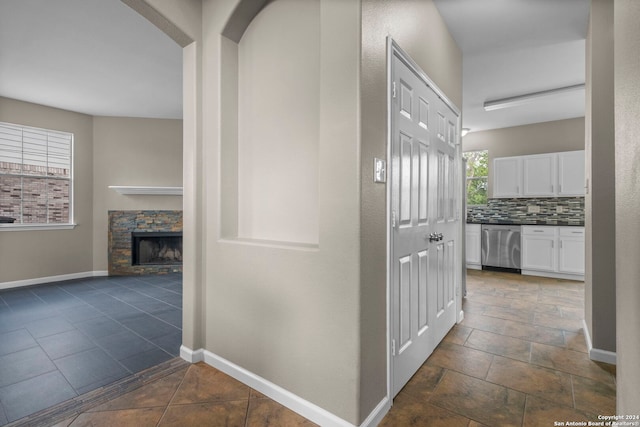 hall featuring dark tile floors