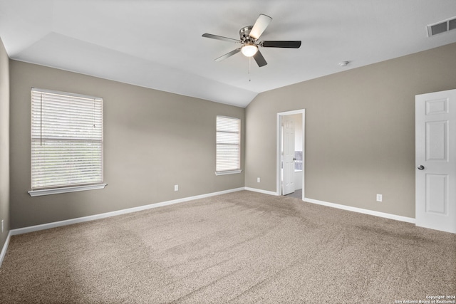 carpeted empty room with ceiling fan and lofted ceiling